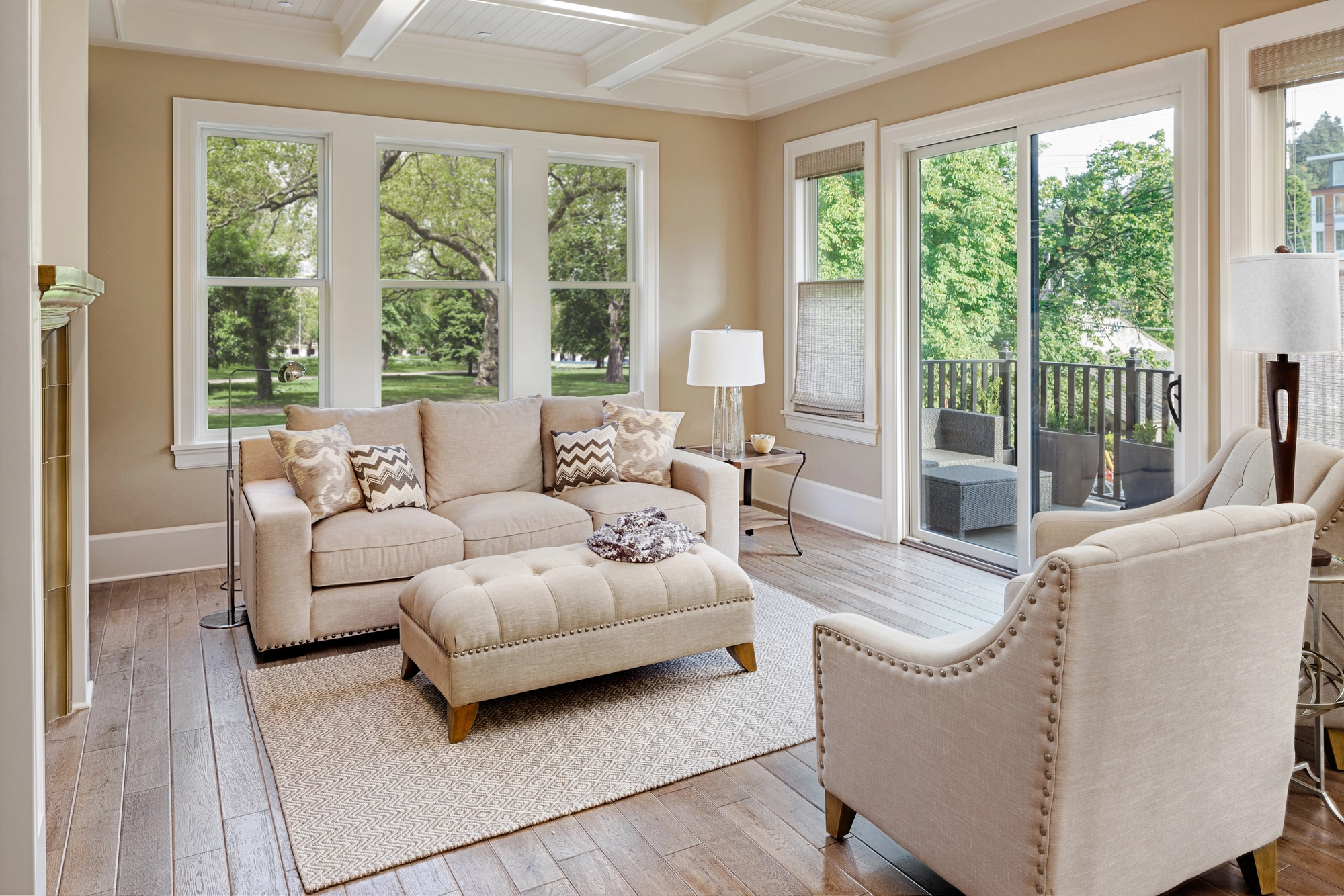 Living room with large energy efficient windows and sliding glass door, bringing in natural light and views of greenery outside