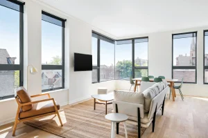 Modern living room with large low maintenance windows allowing natural light and clean architectural lines