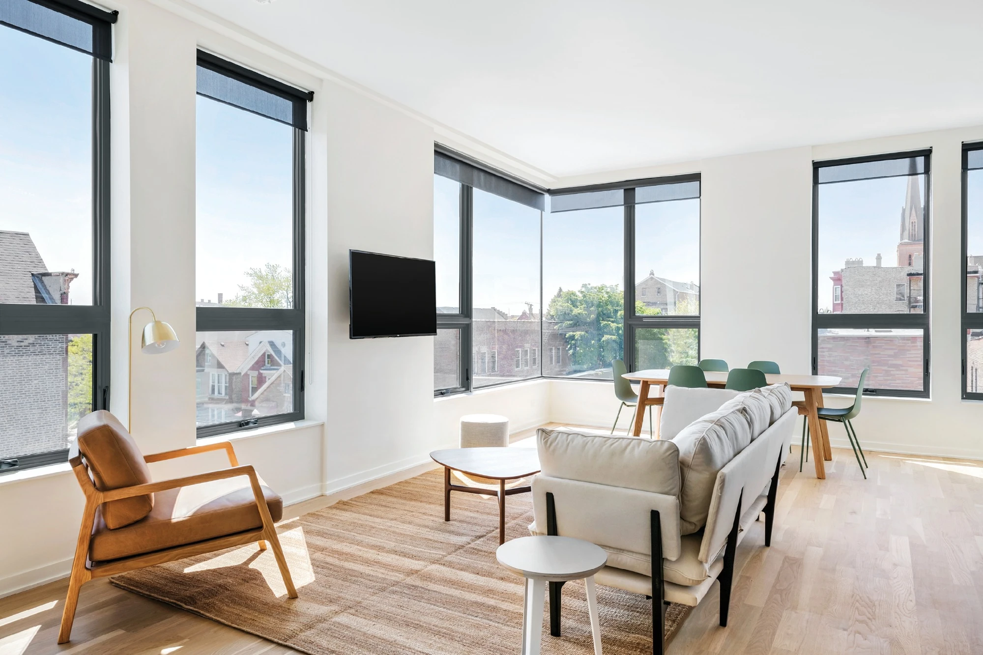 Modern living room with large low maintenance windows allowing natural light and clean architectural lines