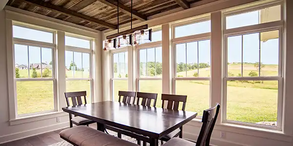 image of dining room with large white vinyl windows benefits