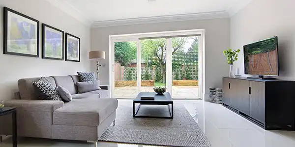 image of bright living room with sliding vinyl patio doors, can you paint vinyl doors example
