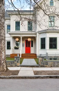 Image of a consultant helping a homeowner decide when to replace a front door by reviewing material samples