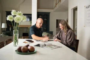 Image of a consultant helping a homeowner decide when to replace a front door by reviewing material samples
