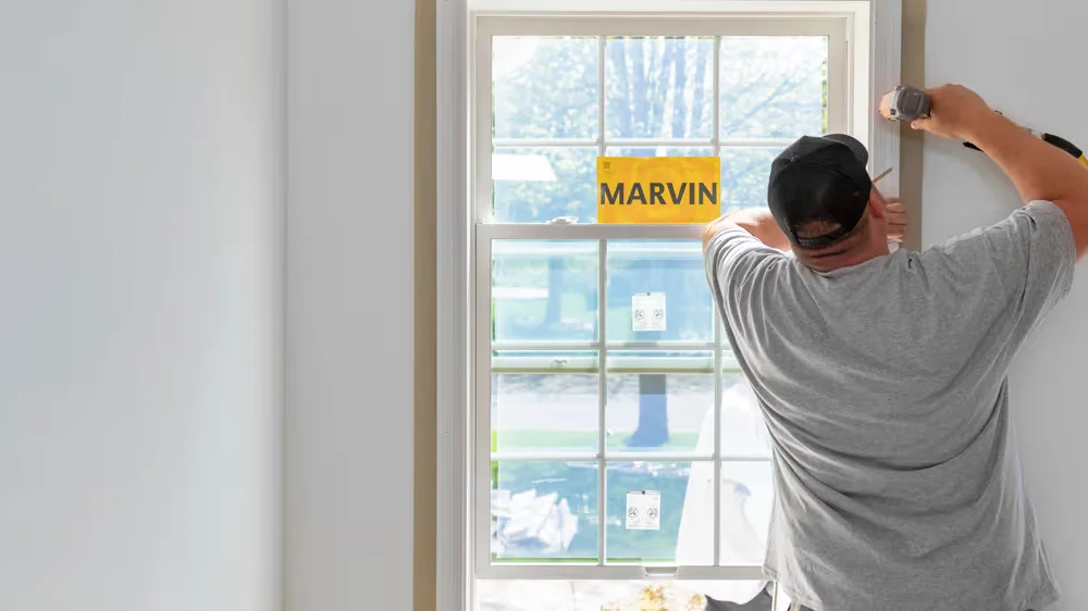 Image of a contractor installing a new Marvin window during a professional home window replacement project