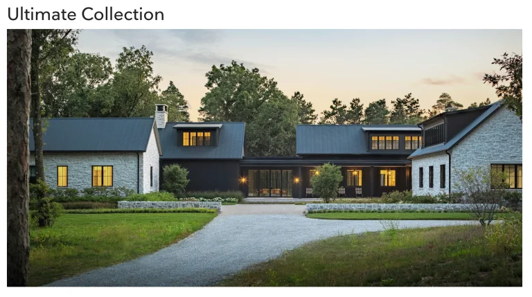 Image of Ultimate Collection Marvin windows on luxury stone and dark farmhouse exterior at dusk