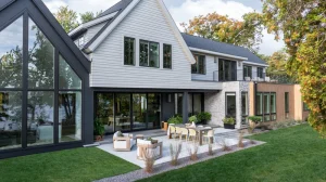 Image of a modern farmhouse exterior with floor-to-ceiling Marvin windows and mixed architectural window styles