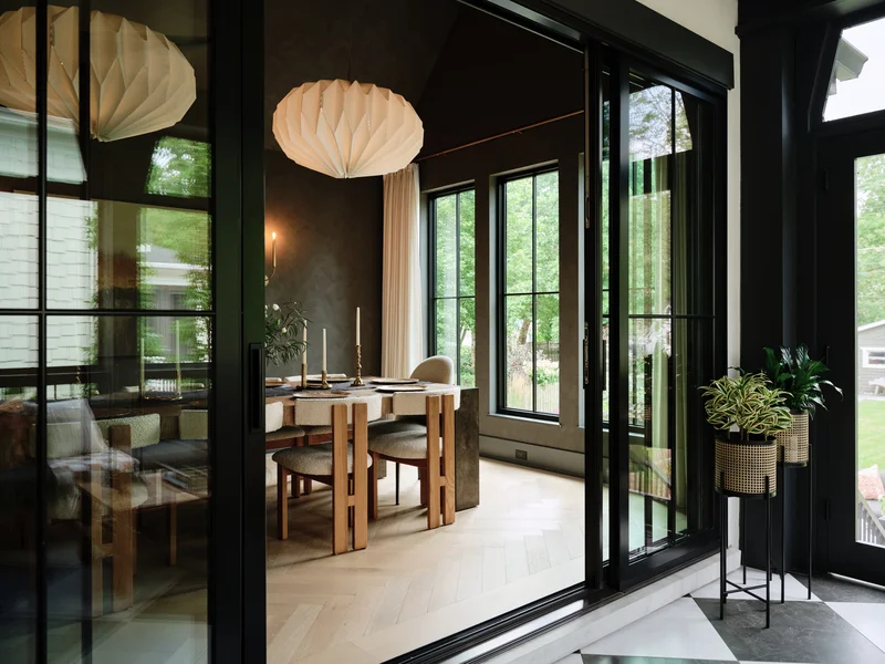 Image of a black-framed sliding patio door leading into a dining room