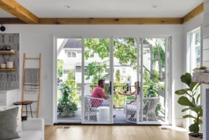 Image of a couple on a deck portraying one of the signs you need a new patio door replacement is style