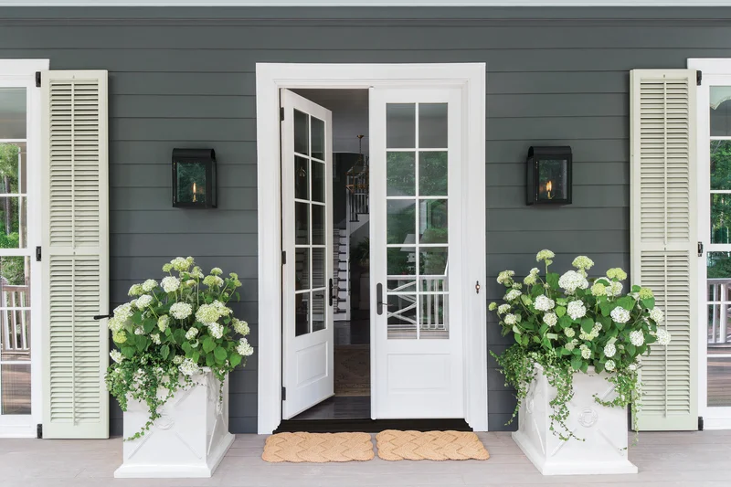 Image of white french doors with divided glass panels on a home entrance