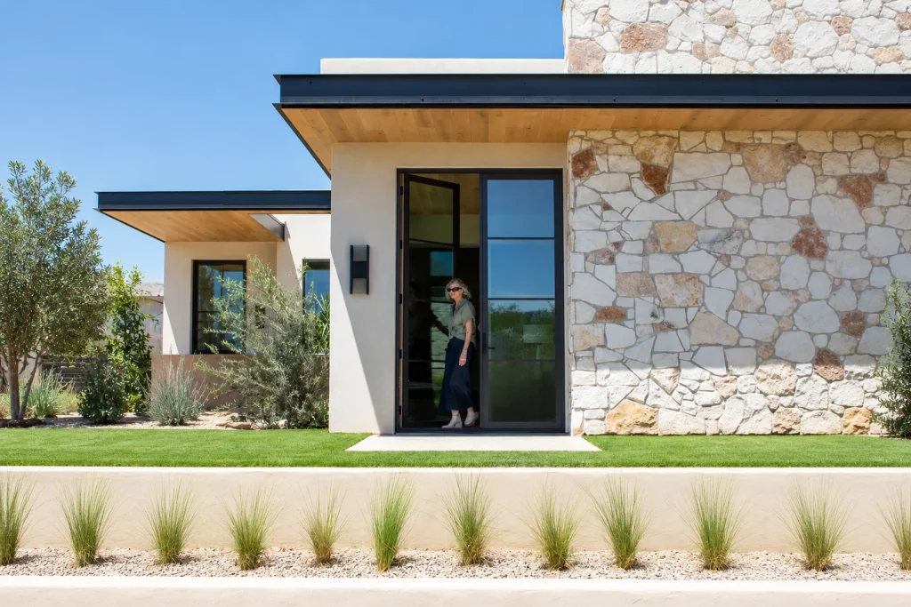 Image of a homeowner exiting a modern home after front door replacement