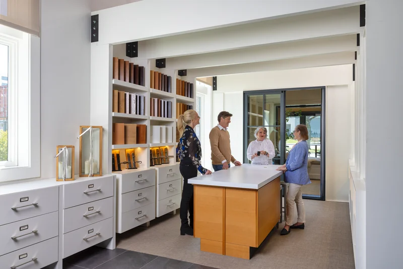 Image of homeowners reviewing material samples during a window consultation